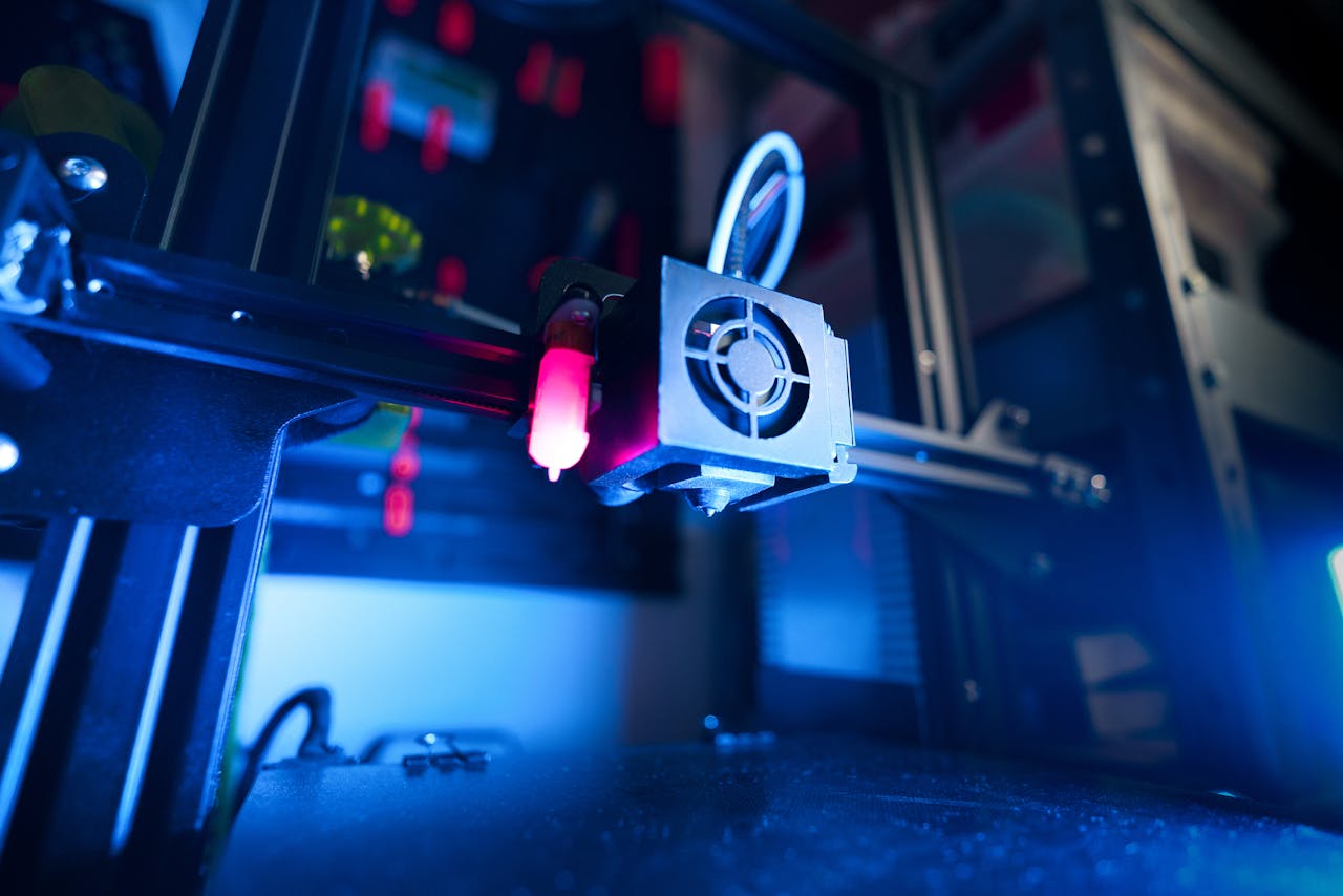 Mastering the First Impression: Your intriguing post title goes here A close-up of an illuminated 3D printer in action, highlighting modern technology.